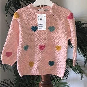 Pretty pink sweater with colorful polka dots
